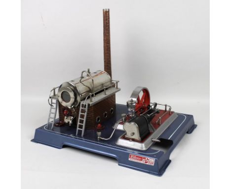 A Wilesco steam engine, with original box, whistle, chimney, valve, pressure gauge and oil, 30 by 28 by 12cm high.