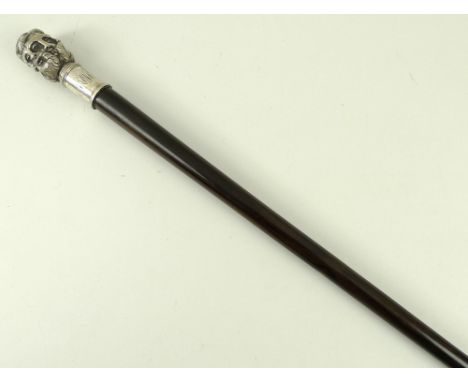 A rosewood walking stick with white metal handle, cast with six classical bearded male faces, engraved initials to the collar