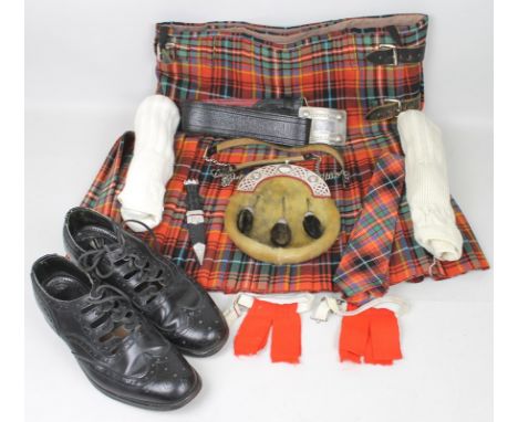 A gentleman's kilt in the Innes tarten, complete with sporren, dress shoes, dirk, tie, two dress jackets and waistcoats, a tw