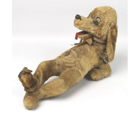 A Rock Valley Toys automaton dog with reclining plush body, open mouth, and key winder, in working order.