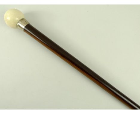 A lignum vitae walking stick with later added ivorine ball handle, white metal collar and brass ferrule, 91.5cm.