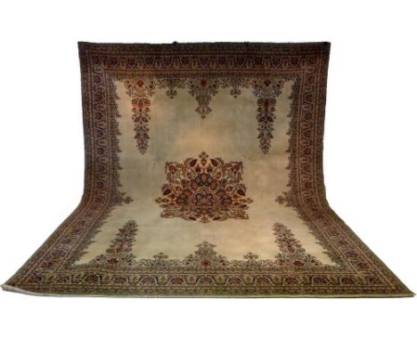 A mid 20th century Axbury carpet, with open beige ground, central floral and foliate medallion, dark blue, red and camel colo