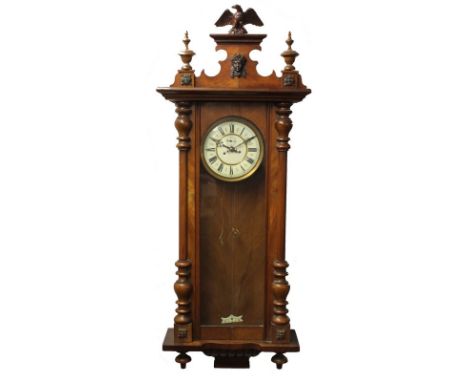 A Vienna wall clock, with Roman numerals, with pendulum, two weights, and winder, 45 by 17 by 123cm. 