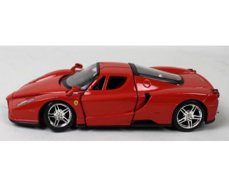 A group of model cars comprising a Maisto 1/24 scale Enzo Ferrari diecast model car, two Scamo Ltd diecast racing cars, Burag