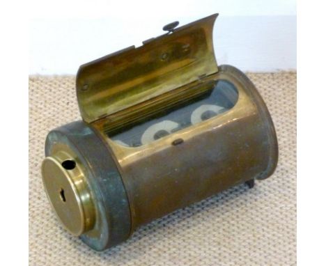 An early to mid 20th century brass cylinder mechanism, possibly a homing pigeon clock, with a set of three paper 'counters' e