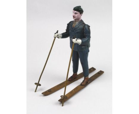 A very rare Lehmann clockwork 'Skirolf' skier, the tinplate body lithographed in blue suit, shirt and tie, with brown boots, 