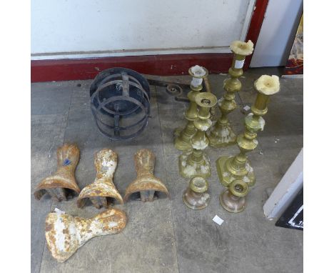 Three pairs of brass candlesticks, a wrought steel lantern wall light and a set of four Victorian cast iron bath feet 