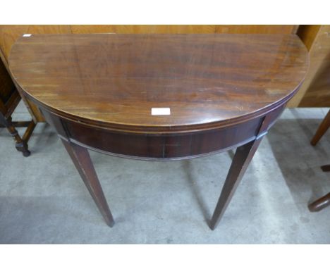 A George III mahogany demi-lune fold over card table 