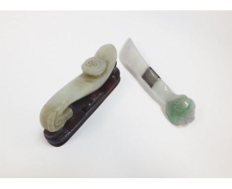 A Chinese pale green jade belt hook Late Qing Dynasty Carved with a dragon head, the curved shaft with circular boss to the b
