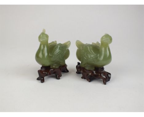 A pair of Chinese celadon jade figures of birds Modelled as semi-stylised crested water birds, facing slightly left and right
