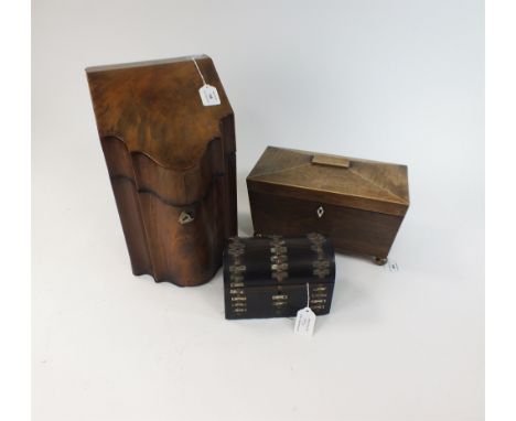 A 19th Century mahogany tea caddy Of sarcophagus form and raised on four brass ball feet, the interior with inlaid rosewood b