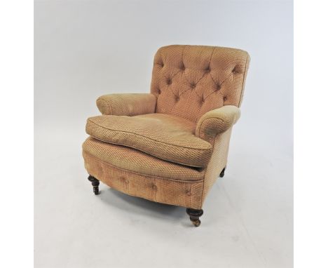 A Victorian salmon pink upholstered chair, the later button back upholstery over a drop-in cushion and raised on squat turned