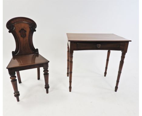 A 19 th century mahogany table, the rectangular top above two concave opposing frieze drawers, raised on ringturned tapering 