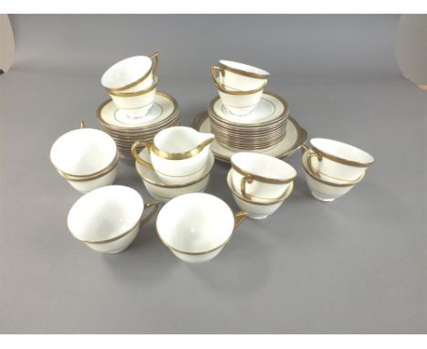 A Royal Doulton 39 piece tea service in the Agincourt pattern, white with gilding