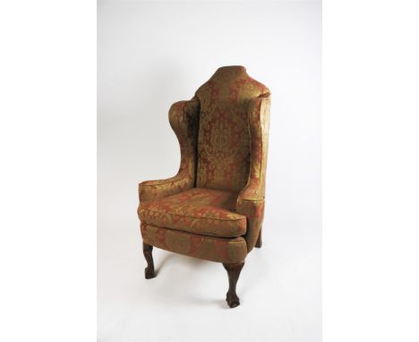 A George I style wing back armchair, 20th century, with crimson and cream foliate piped covers and raised on cabriole front l
