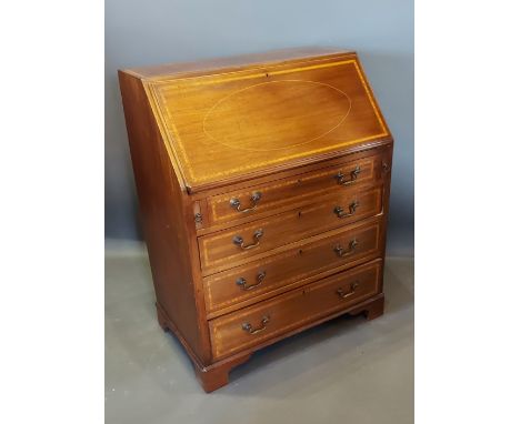 An Edwardian mahogany satinwood inlaid bureau, the fall front above four drawers with brass handles raised upon bracket feet,