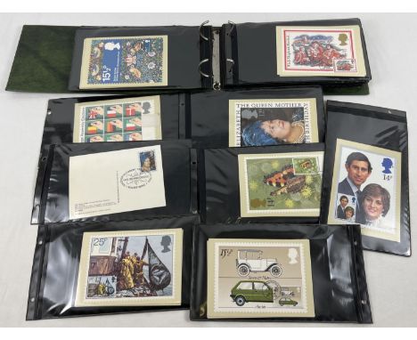 An album containing 100+ assorted stamped first day issue PHQ cards. 