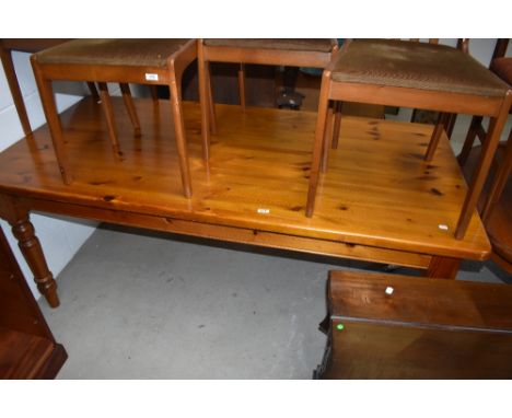 A modern light pine farm house style solid kitchen table