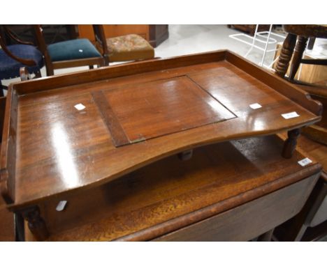 A vintage stained frame bed tray
