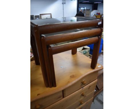 A vintage teak and glass nest of three tables