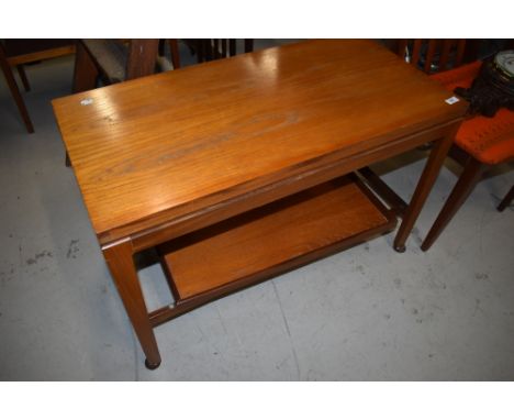 A vintage teak fold over coffee table