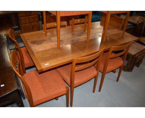 A vintage teak and tiletop extending dining table and either complimentary dining chair
