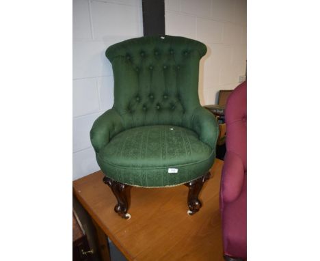 A Victorian button back nursing chair having green upholstery and knurled legs