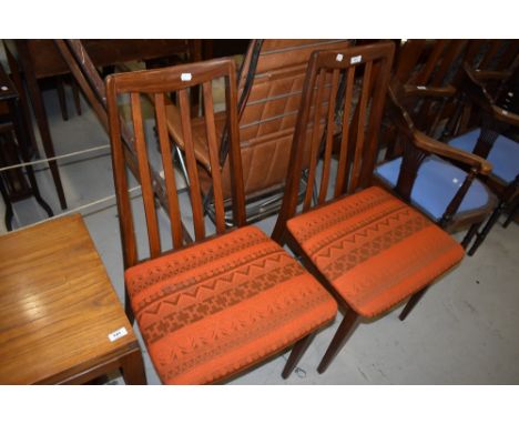 A pair of vintage teak rail back dining chairs