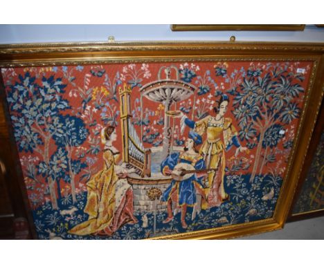 A large gilt framed woolwork tapestry depicting classical maidens and minstral