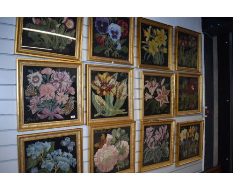 A set of twelve framed floral tapestry works, in gilt frames