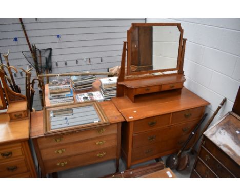 An arts and crafts made dressing table in light oak with a similar chest of three drawers