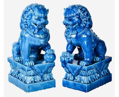 FOO DOGS, a pair, 40cm high, 15cm wide, 25cm deep, cobalt blue glazed ceramic. (2) 