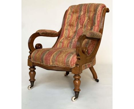 ARMCHAIR, 19th century mahogany framed, buttoned paisley upholstery, with scroll arms and ceramic castors. 