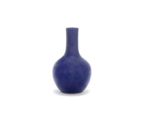 An aubergine glazed bottle vaseKangxiThe bulbous body rising to a broad cylindrical neck, the glaze of rich violet tone. 31cm
