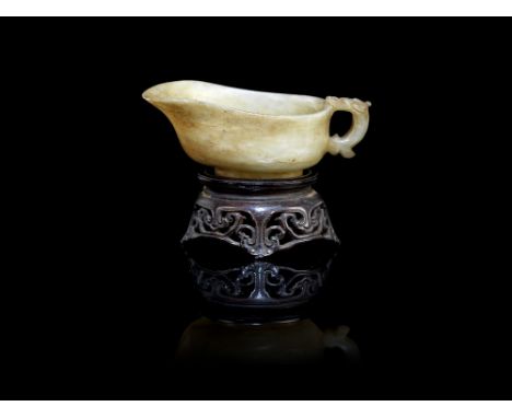 A jade pouring vesselLate Ming Dynasty, 17th centuryWith carved chilong handle, the stone of pale green tone with creamy and 