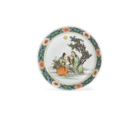 A famille verte figural dishKangxiDecorated with a central scene of a lady serving tea to a gentleman seated beneath a tree, 