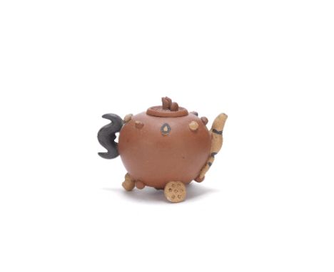 Two Yixing zisha teapots and coversQing DynastyThe first of compressed pear-shape, with circular loop handle and s-shaped spo