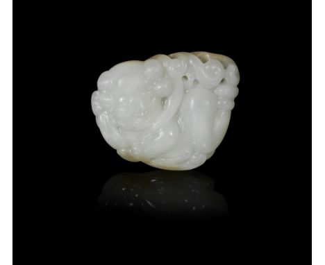 A white jade carving of an apsaraCarved in the round and openwork as a boy-deity in flight, wearing a long flowing scarf, his