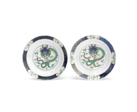 A pair of famille verte 'dragon' dishesKangxiEach decorated in underglaze blue, coloured enamels and gilt with a large centra