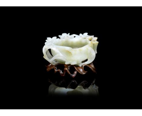 A pale green jade peach-form washer18th/19th centuryCarved in openwork relief with blossoming branches encircling the vessel 