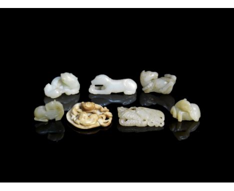 A group of seven jade animal carvingsMing Dynasty and laterComprising: a cream jade carving of a cat and a kitten on a leaf; 
