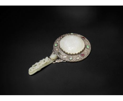 A jade and white metal mounted mirror19th centuryWith openwork chilong belt hook forming the handle and rounded convex plaque