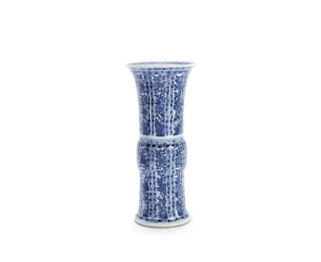 A blue and white sleeve vase, guKangxiDecorated with panels of flowering magnolia, peonies, camelia and blossoming prunus amo