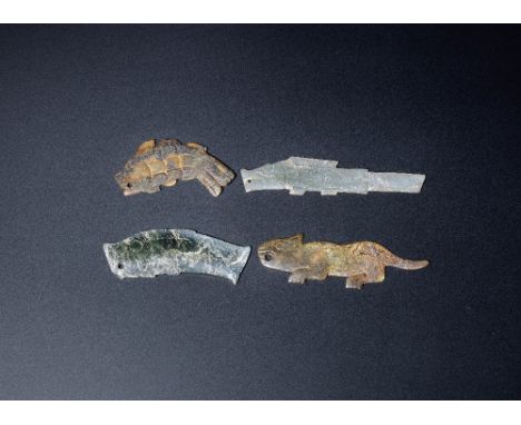 A group of archaic jade zoomorphic pendantsWestern Zhou DynastyComprising: a mottled jade carving of a leaping fish, finely i