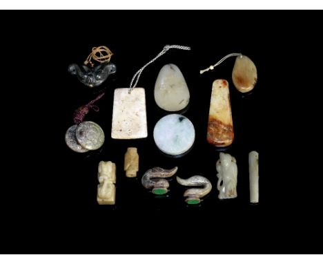 A group of fourteen jade and hardstone carvingsIncluding archaistic forms, discs, pendants and a figural carving.The largest 