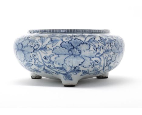 A Blue and White tripod incense burnerWanliOf bombe form, decorated with six large peony blooms issuing from scrolling, leafy