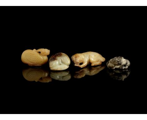 A group of four jade animal carvingsPossibly Han Dynasty and laterComprising: a pale green and russet skinned carving of a re