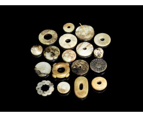 A group of eighteen archaistic jade bi discs, sword fittings and carvingsHan Dynasty and laterVariously of green, grey, russe