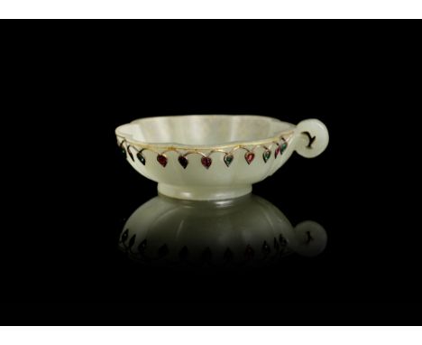 A Mughal Jade flower-form cup18th centuryCarved with a furled acanthus leaf handle, with a gold and gem-set interlaced petal 