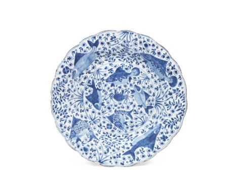 A large blue and white 'fish' dishKangxiWith foliate rim, decorated with a variety of fish and a crab amongst aquatic plants,